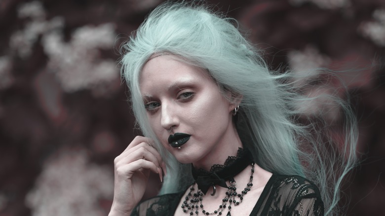 person with dark teal lipstick