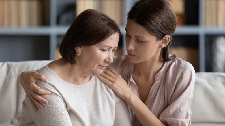 Young woman consoling older woman