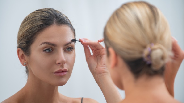 Woman brushing brows