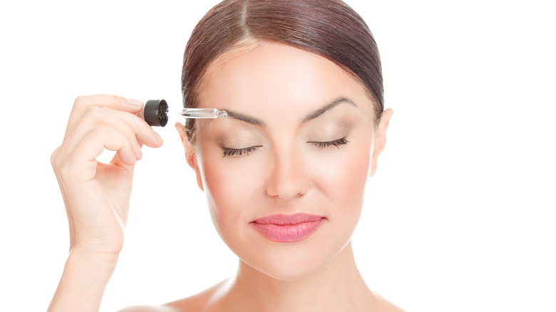 Applying eyebrow serum