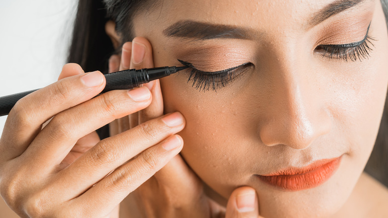 Woman applying eyeliner