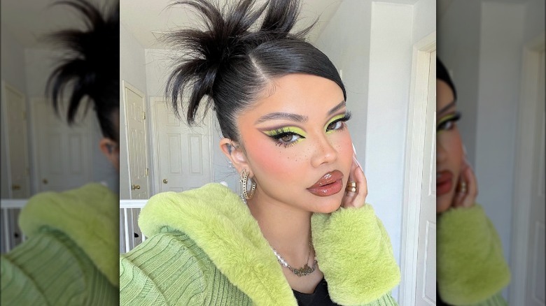 Woman with spiky bun and side part