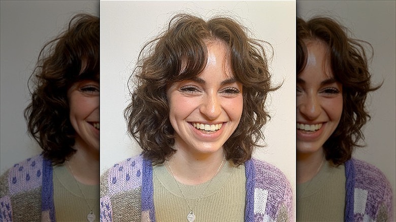 woman with curly curtain bangs