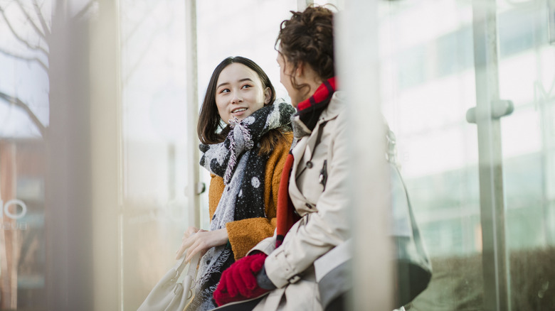 two women talking outside