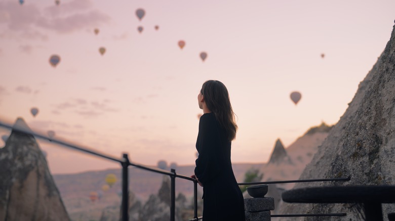 Woman watching hot air balloons 