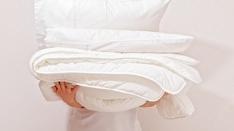 Person holding pillows