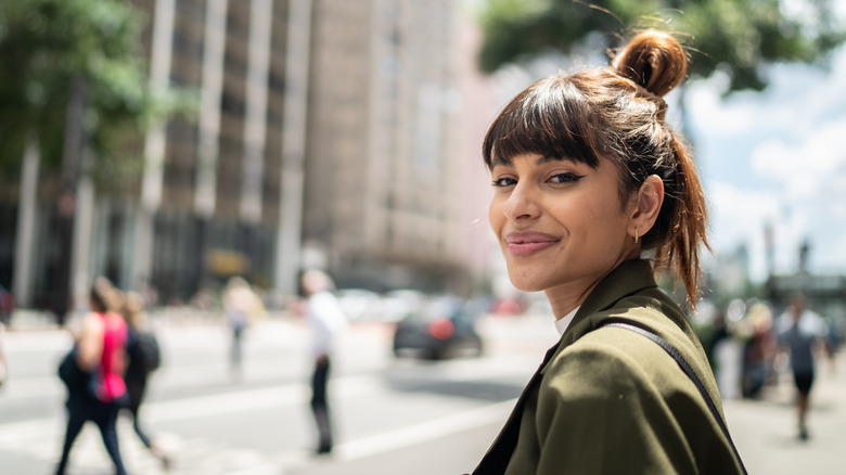Woman smiling in green blazer