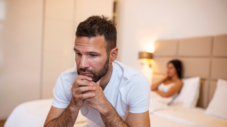 Stressed couple on a bed