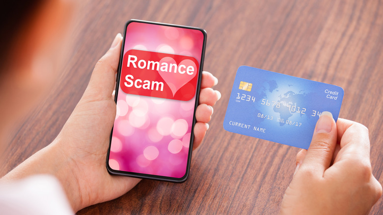 person holding phone and credit card 