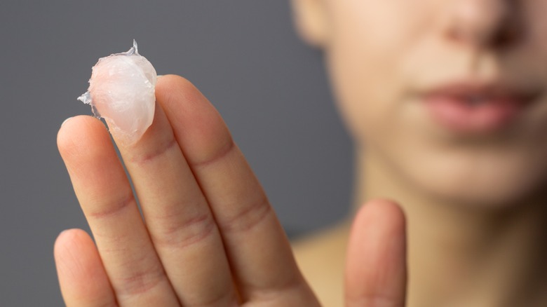 Woman with glob of petroleum