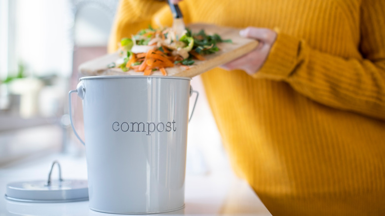 placing food waste into compost