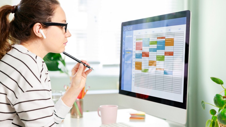 A woman looking at her calendar on a computer