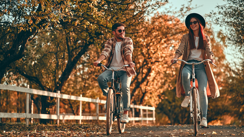 A man and a woman riding bikes