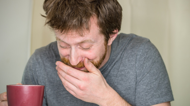 man trying to cover spit
