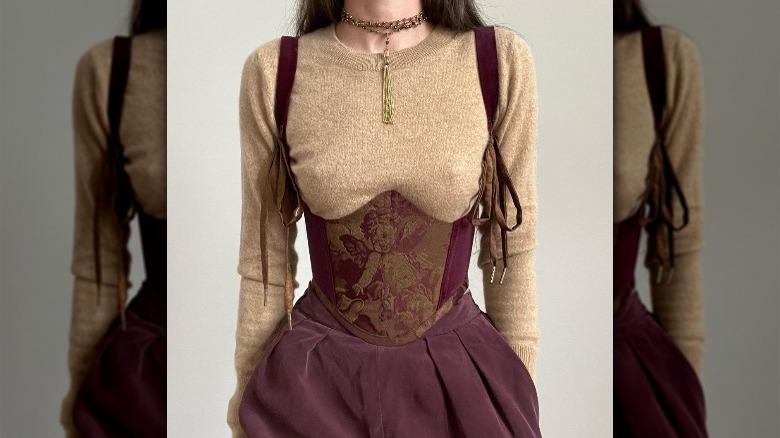 Woman wearing a burgundy corset top