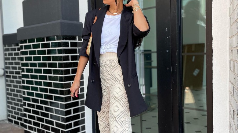 woman wearing white crochet pants