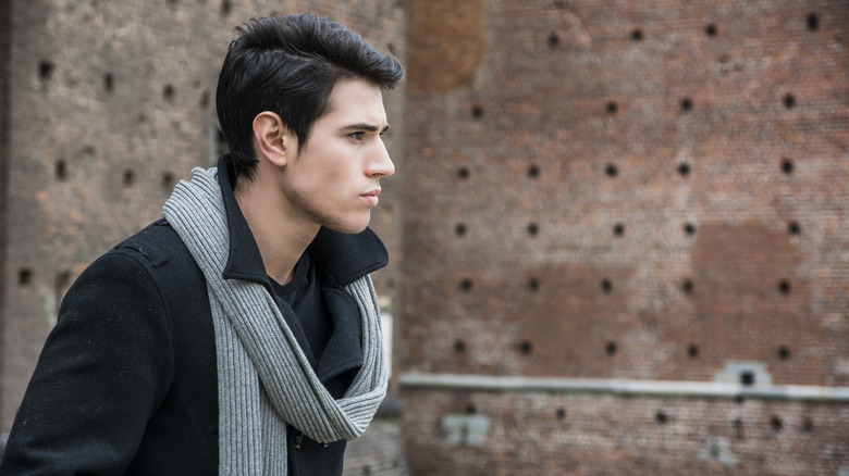 man with scarf over the shoulder