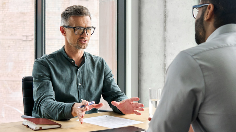 Older man talking to boss