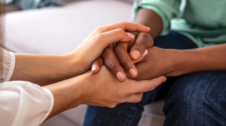 two people holding hands