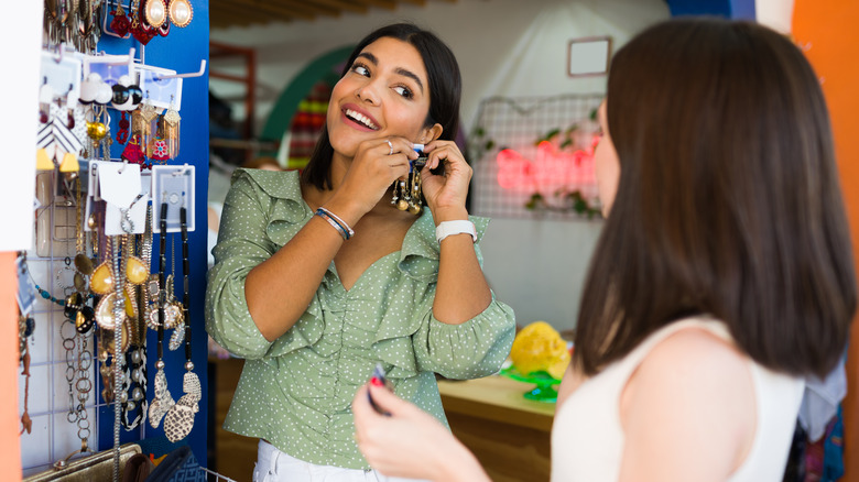 Two women examining jewelry at a thrift store