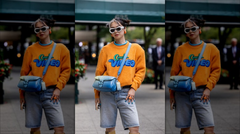 woman wearing Bermuda shorts and sweater