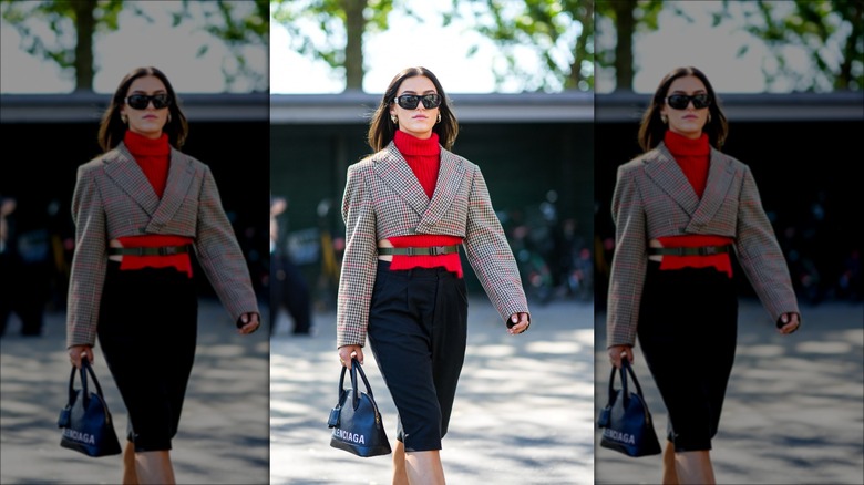woman wearing blazer and Bermuda shorts