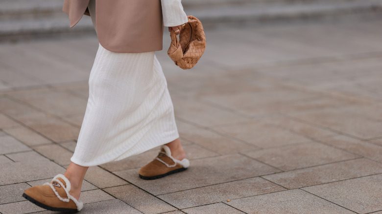 person in fur-lined flats