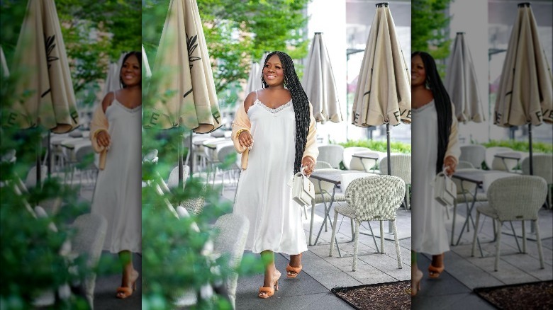 Woman with cardigan over slip dress.