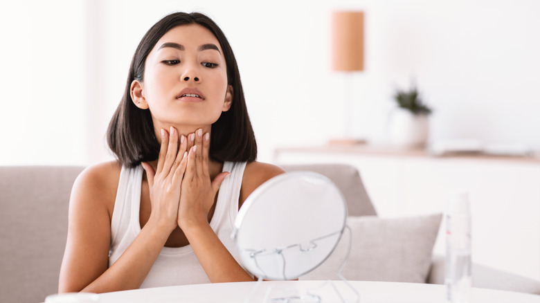 woman massaging neck 