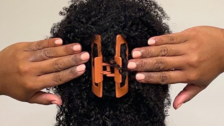 Girl with curly hair and claw clip