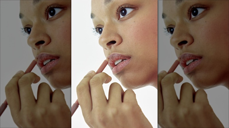 woman applying lip liner