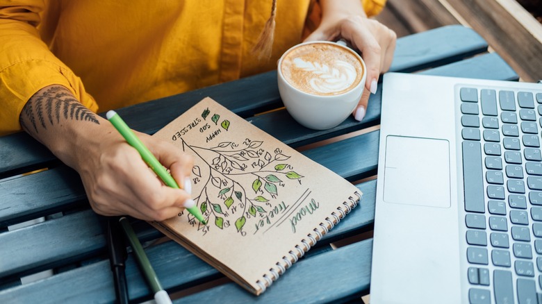 Person writing in mood tracker journal