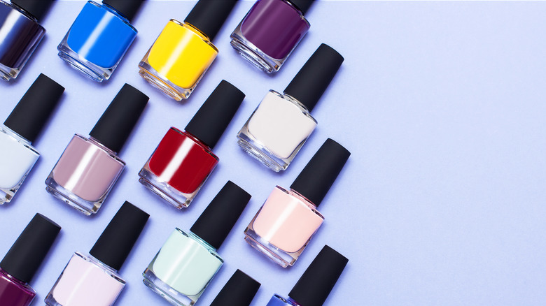 Different colors of nail polish, including white, laid out incrementally 
