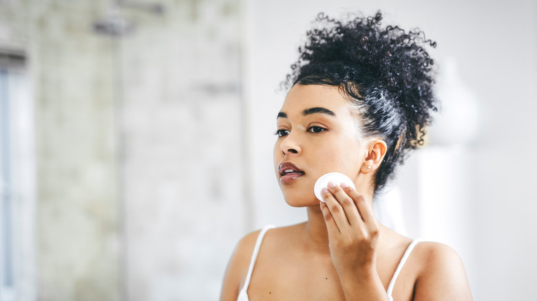 woman washing off makeup