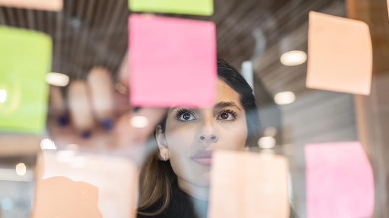 Woman examining Post-it notes