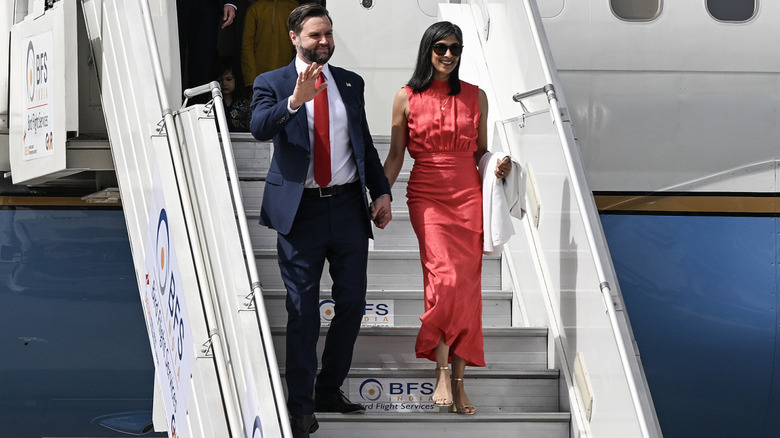JD and Usha Vance descending an airplane's stairs