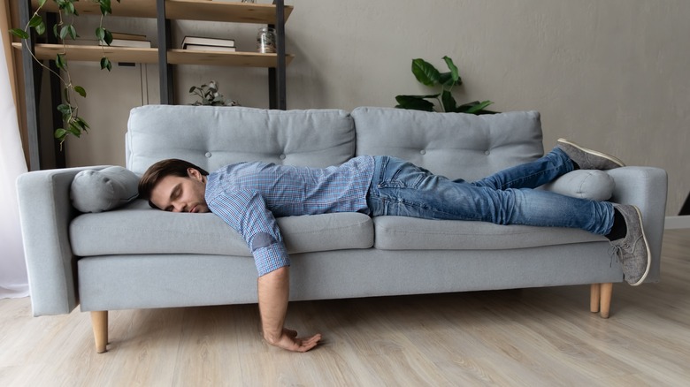 A man sleeping on a couch