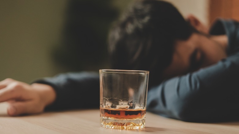 A drunk man with a glass