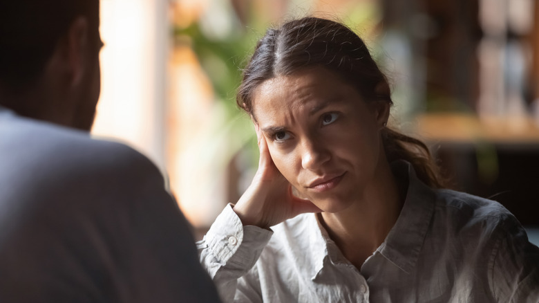 Woman looking annoyed at a man