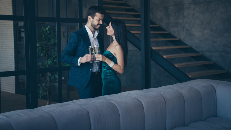 couple toasting in lavish house