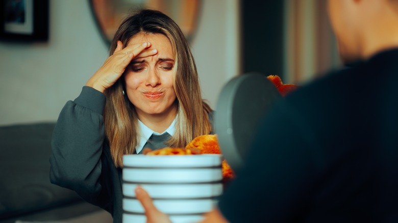 Stressed woman receiving gift
