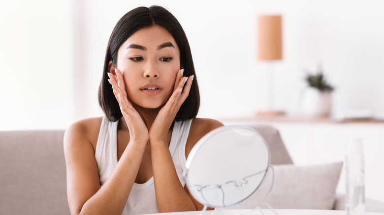 A woman looking in a mirror