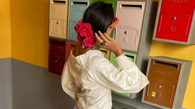 Red flower in dark brown hair