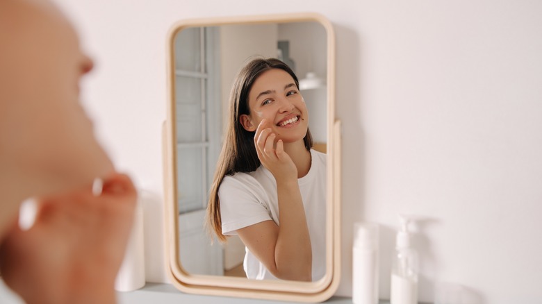 Woman putting on barrier cream