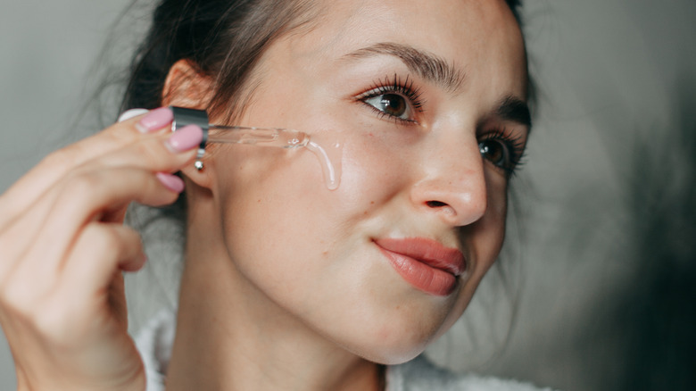 woman applying serum