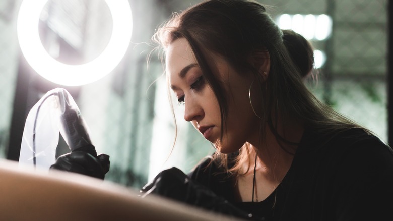 tattoo artist working