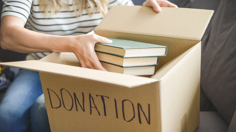Placing books in donation box