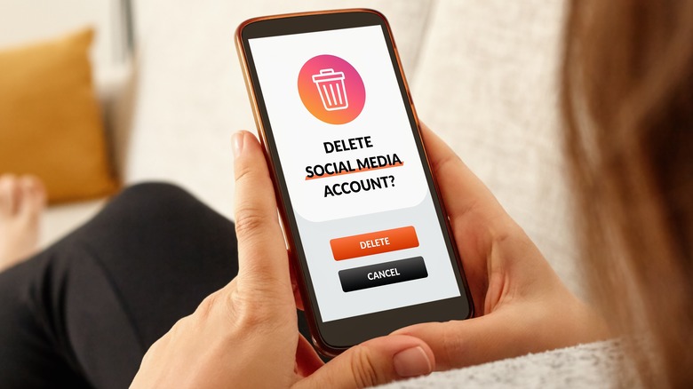 Woman deletes social media account on smart phone