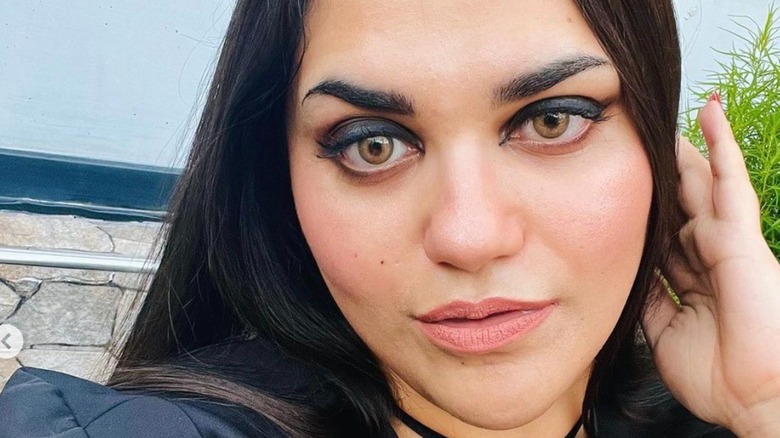 Woman with black eyeshadow and nude lips 