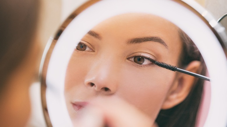 Woman applying mascara